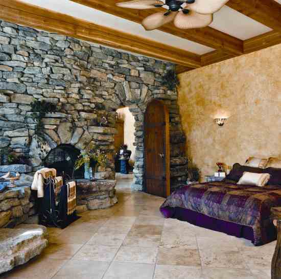 The master suite’s open floorplan includes a see-through fireplace that leads into the main room. For a spa-like feel, the bedroom is open to the soaking tub and walk-in shower.
